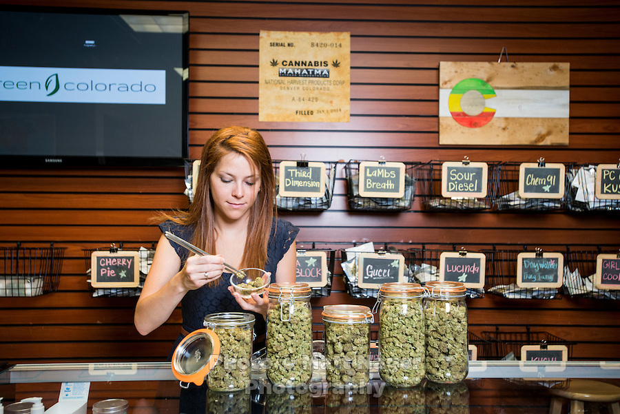 Budtender Jasmine Maimone (cq) behind the counter at a LiveGreen Cannabis store in Denver, Colorado, Monday, July 21, 2014.  Photo by Matt Nager